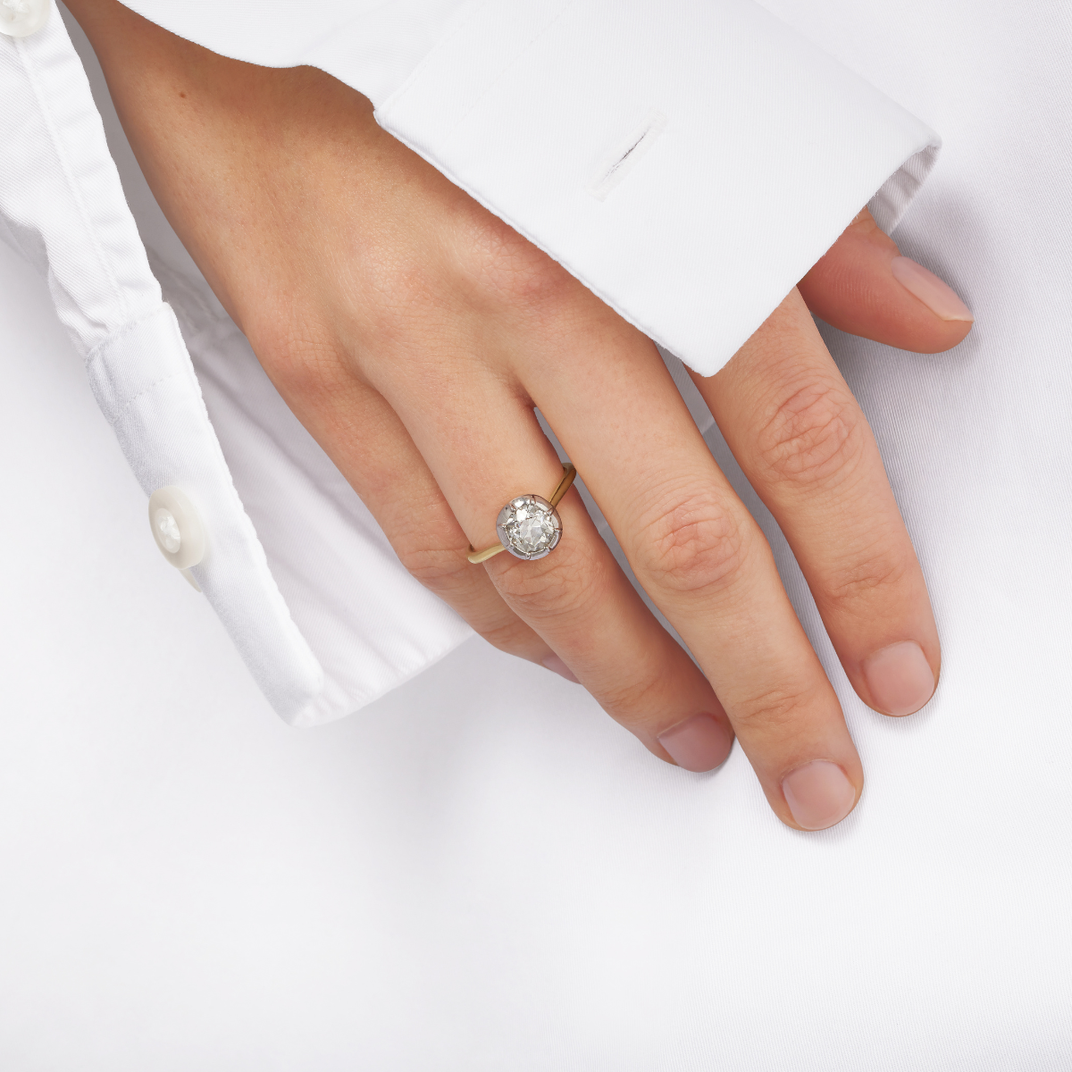 Old cut diamond solitaire engagement ring on model's hand