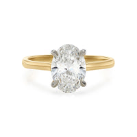 Oval diamond solitaire engagement ring with yellow gold shank