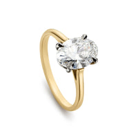 Oval diamond solitaire engagement ring with yellow gold shank