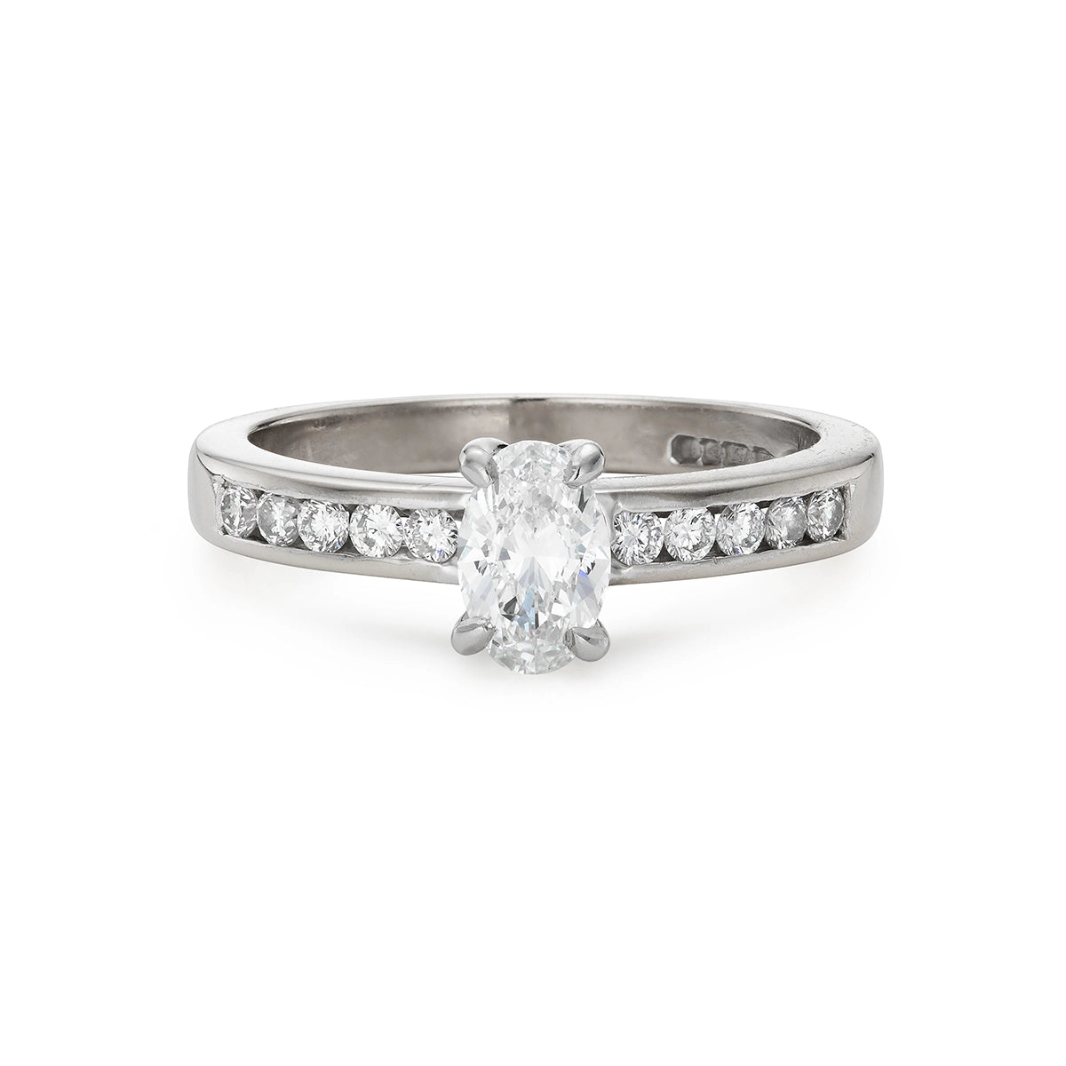 Modern 0.65ct oval diamond engagement ring with channel set diamond band in white gold