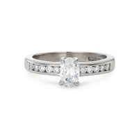 Modern 0.65ct oval diamond engagement ring with channel set diamond band in white gold
