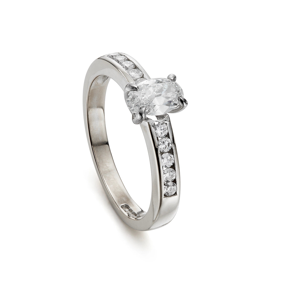 Modern 0.65ct oval diamond engagement ring with channel set diamond band in white gold
