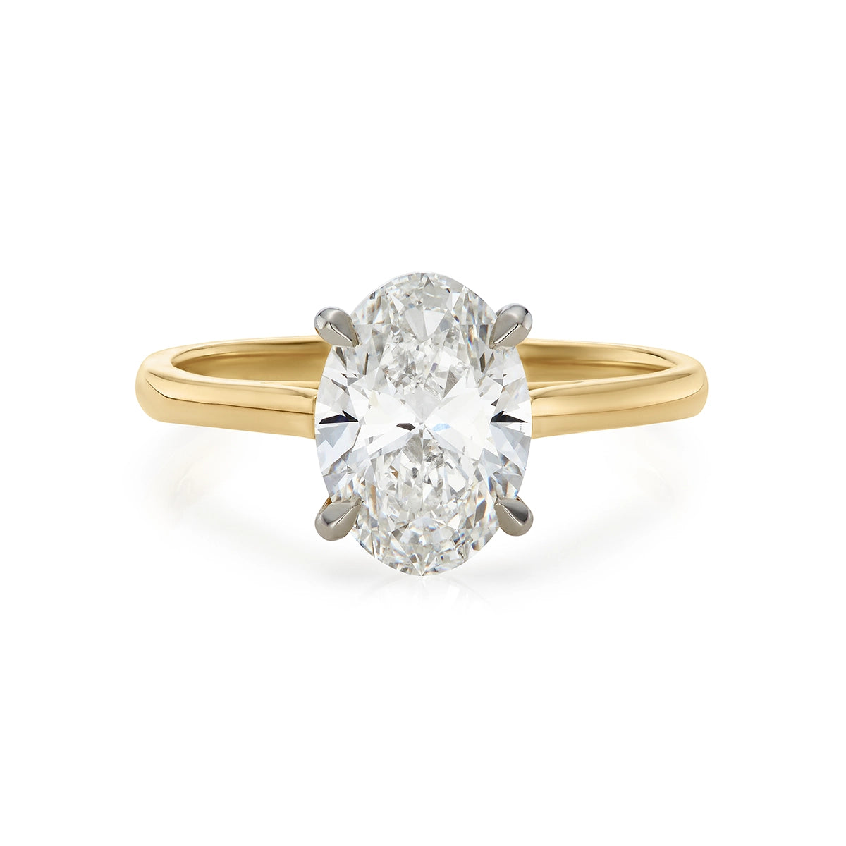 Oval diamond solitaire engagement ring with yellow gold shank 