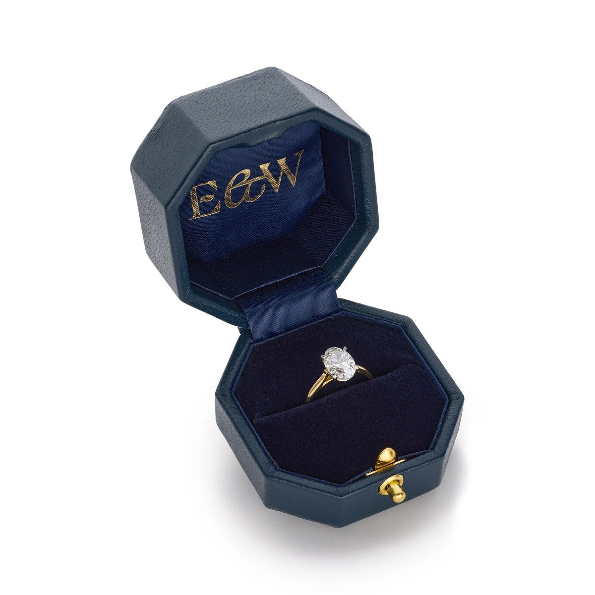 Oval diamond solitaire engagement ring with yellow gold shank in jewellery box