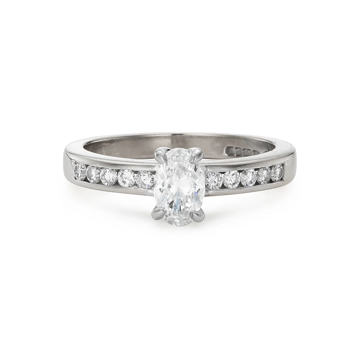 Modern 0.65ct oval diamond engagement ring with channel set diamond band in white gold